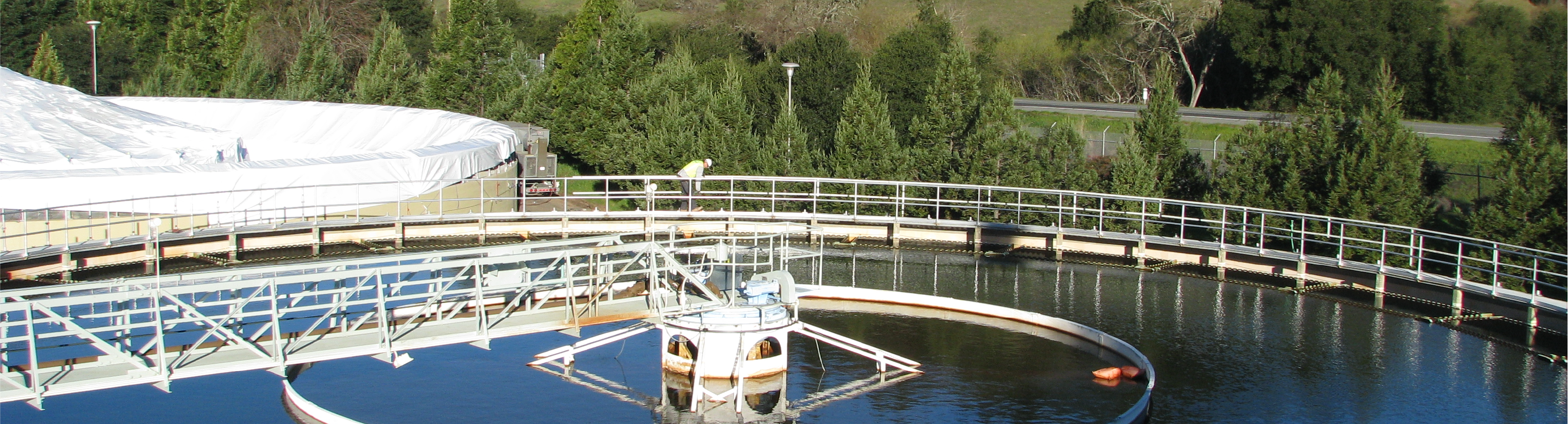 San Geronimo treatment plant clarifiers with green hill in the background