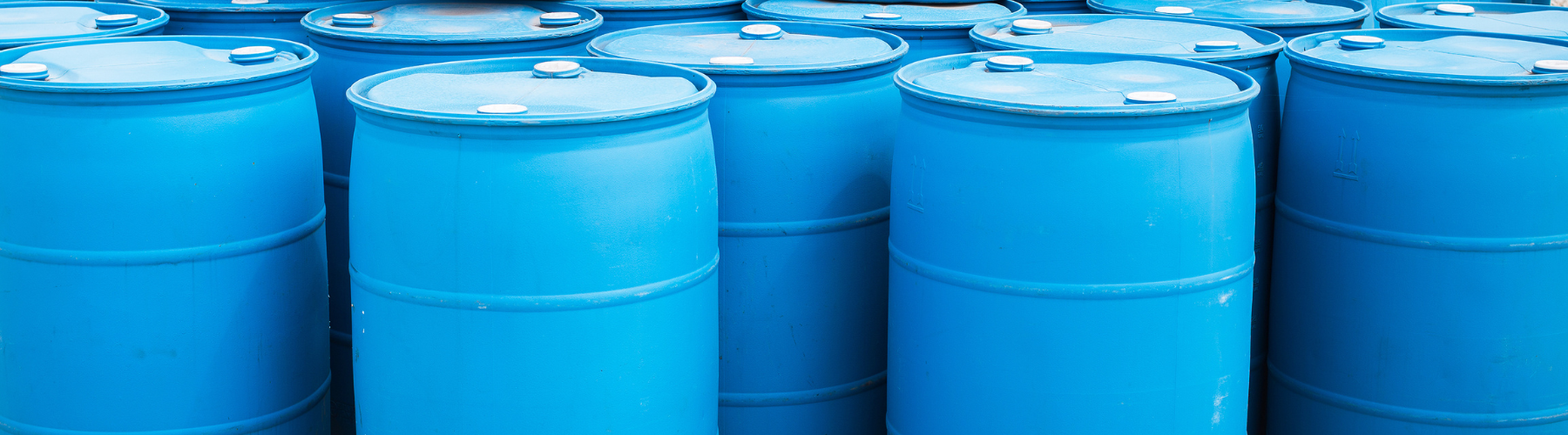Image shows a cluster of blue plastic barrels.