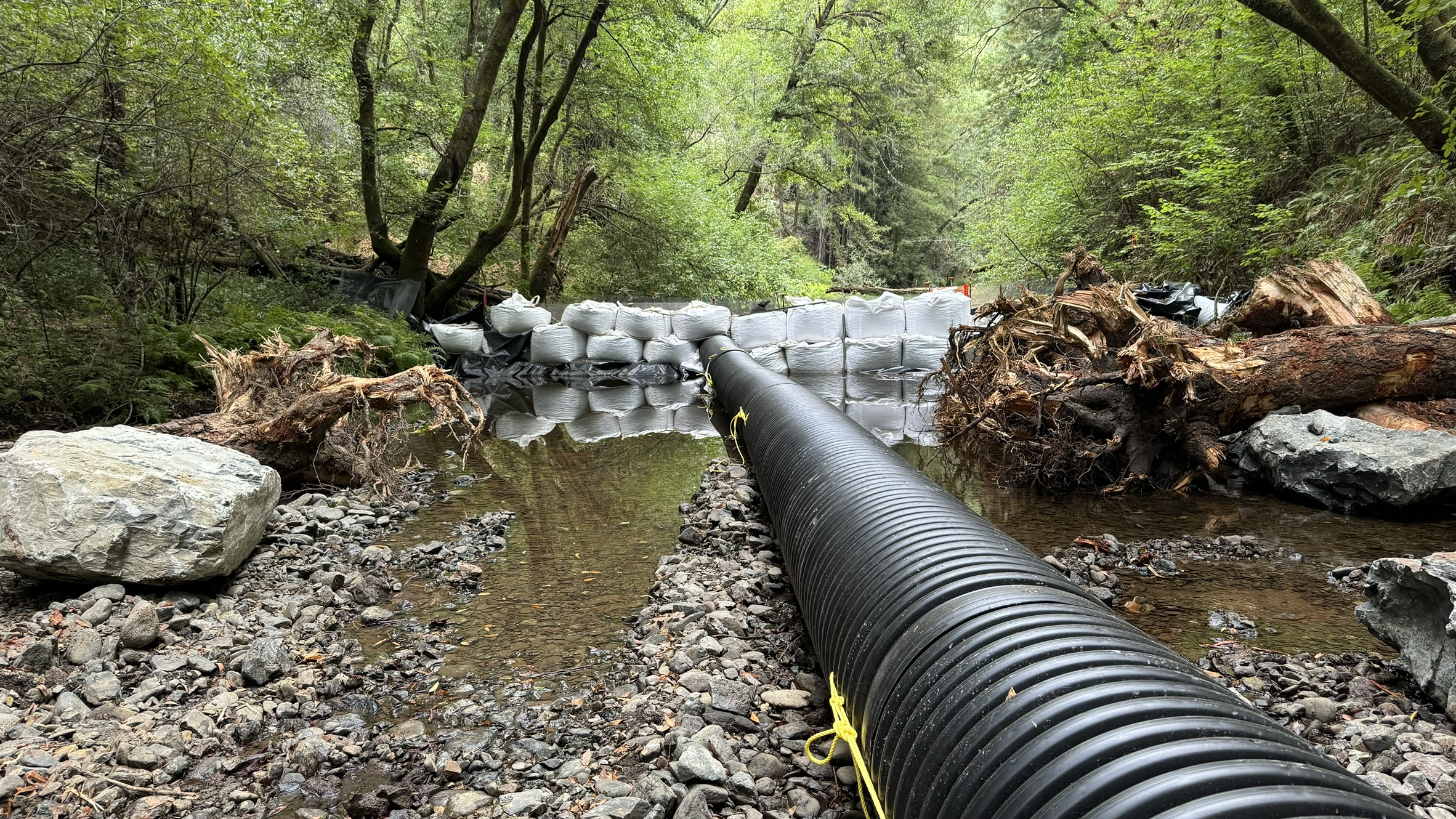 A cofferdam and bypass pipe in a creek