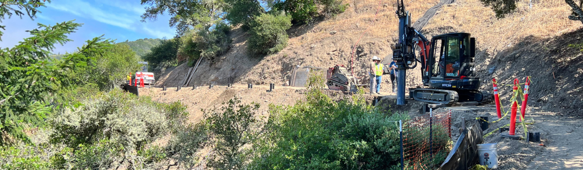 A dirt path with people and equipment. 