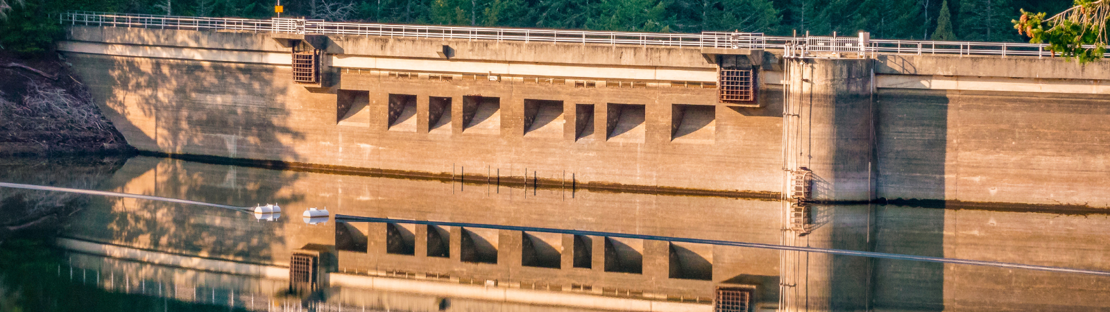 A dam and its reflection on a reservoir