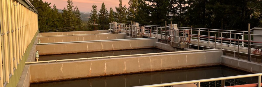 A portion of a water treatment plant surrounded by trees.