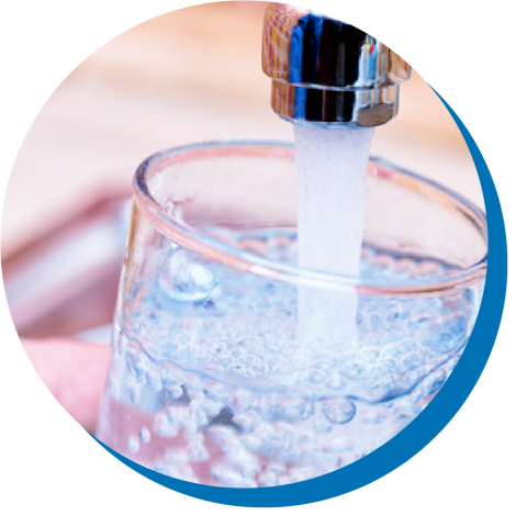 glass of water under faucet