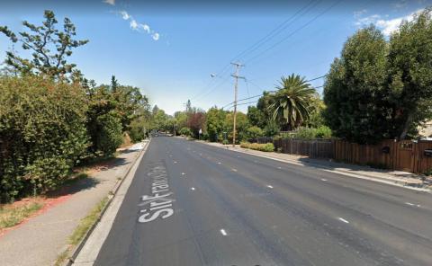 A street flanked with sidewalks and trees