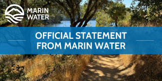 A photo of a shady trail near water with a graphic circle logo of a mountain and water and the words "MARIN WATER" in the corner. A blue graphic banner runs across the image with the words "OFFICIAL STATEMENT FROM MARIN WATER".