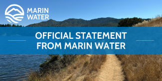 A graphic of a mountain and water with the words "MARIN WATER" and a banner with the words "OFFICIAL STATEMENT FROM MARIN WATER" are overlayed on an image of a mountain, lake and trail. 