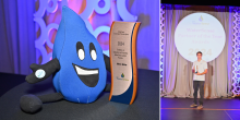 A person holds an award on a stage displaying a backdrop that reads “WaterSense Partner of the Year Awards 2024.”