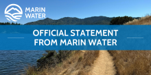 A graphic of a mountain and water with the words "MARIN WATER" and a banner with the words "OFFICIAL STATEMENT FROM MARIN WATER" are overlayed on an image of a mountain, lake and trail. 