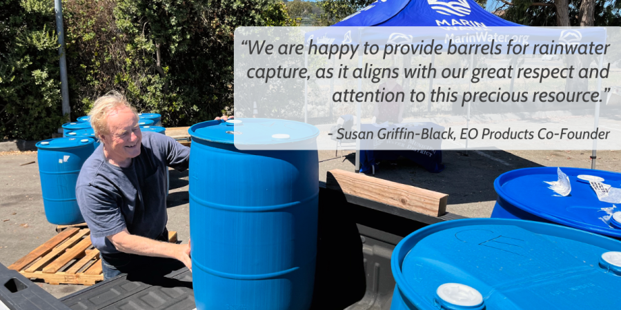 A person pushes a blue barrel into the back of a pickup truck. Superimposed on the picture is a block of text that reads as follows: “We are happy to provide barrels for rainwater capture, as it aligns with our great respect and attention to this precious resource.”  - Susan Griffin-Black, EO Products Co-Founder
