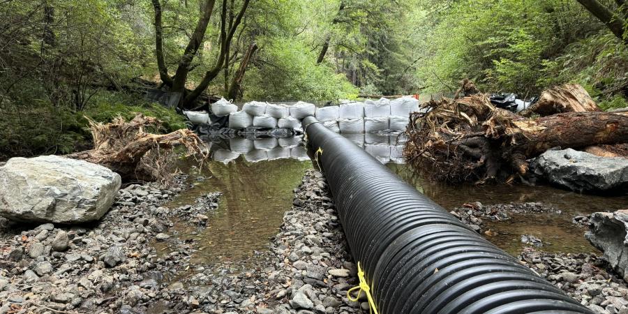 A cofferdam and bypass pipe in a creek