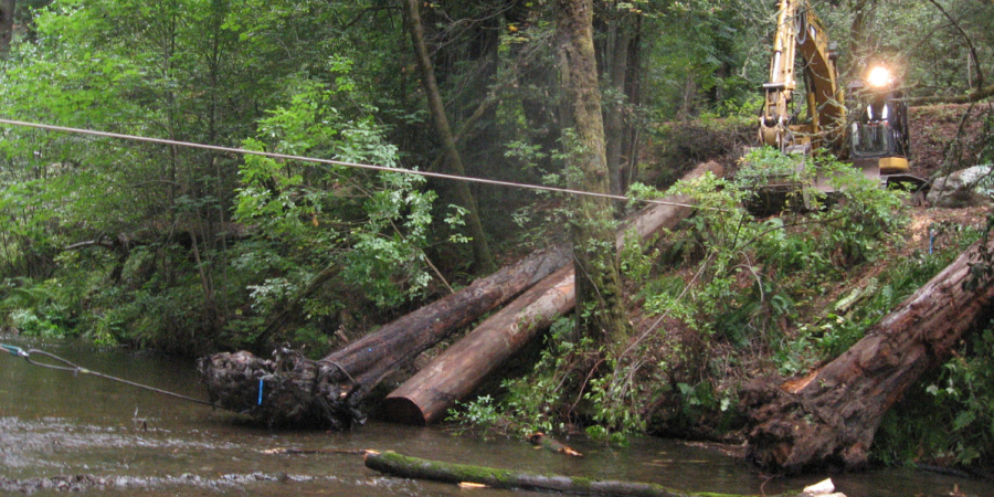 Heavy equipment works near a stream.
